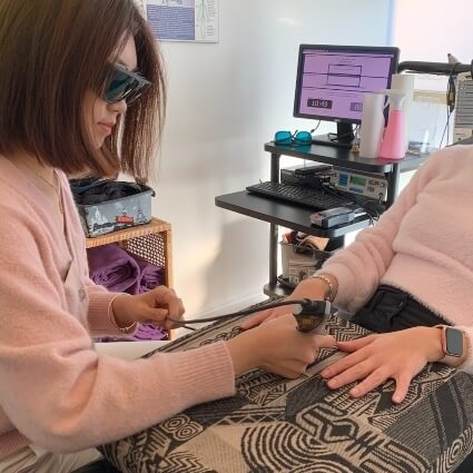 Laser therapy on persons hand