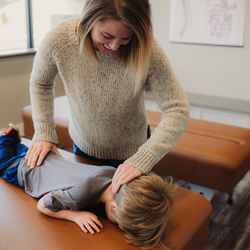 Chiropractor adjusting child