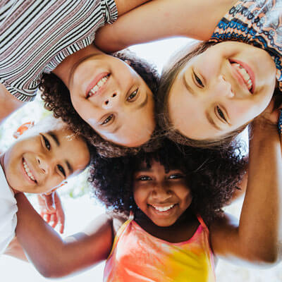 smiling kids looking down at the camera