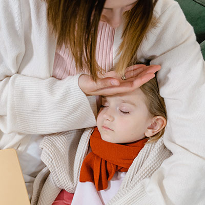 mom taking a sick child's fever