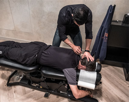 Chiropractor adjusting patient