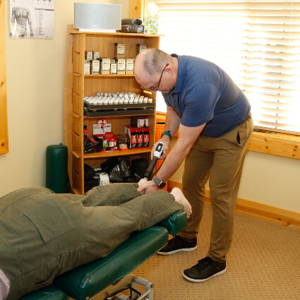 Dr Michael treating patient with shockwave therapy