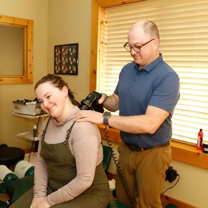 Dr Michael adjusting womans neck