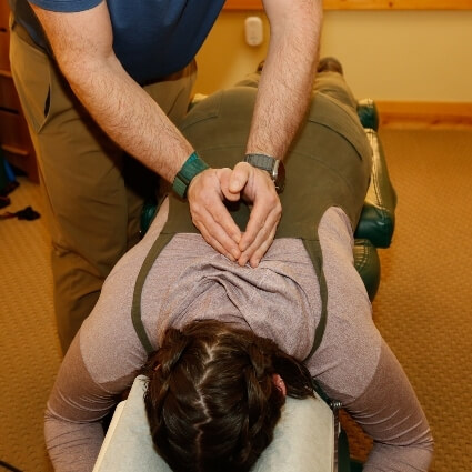 Dr Michael adjusting patients back