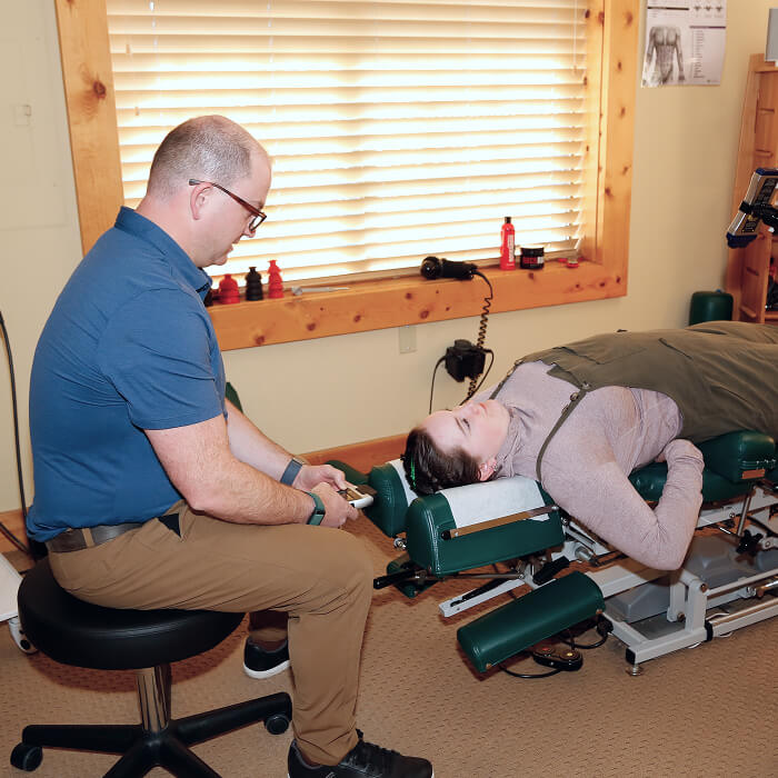 Truckee chiropractor Dr Michael examining patients neck