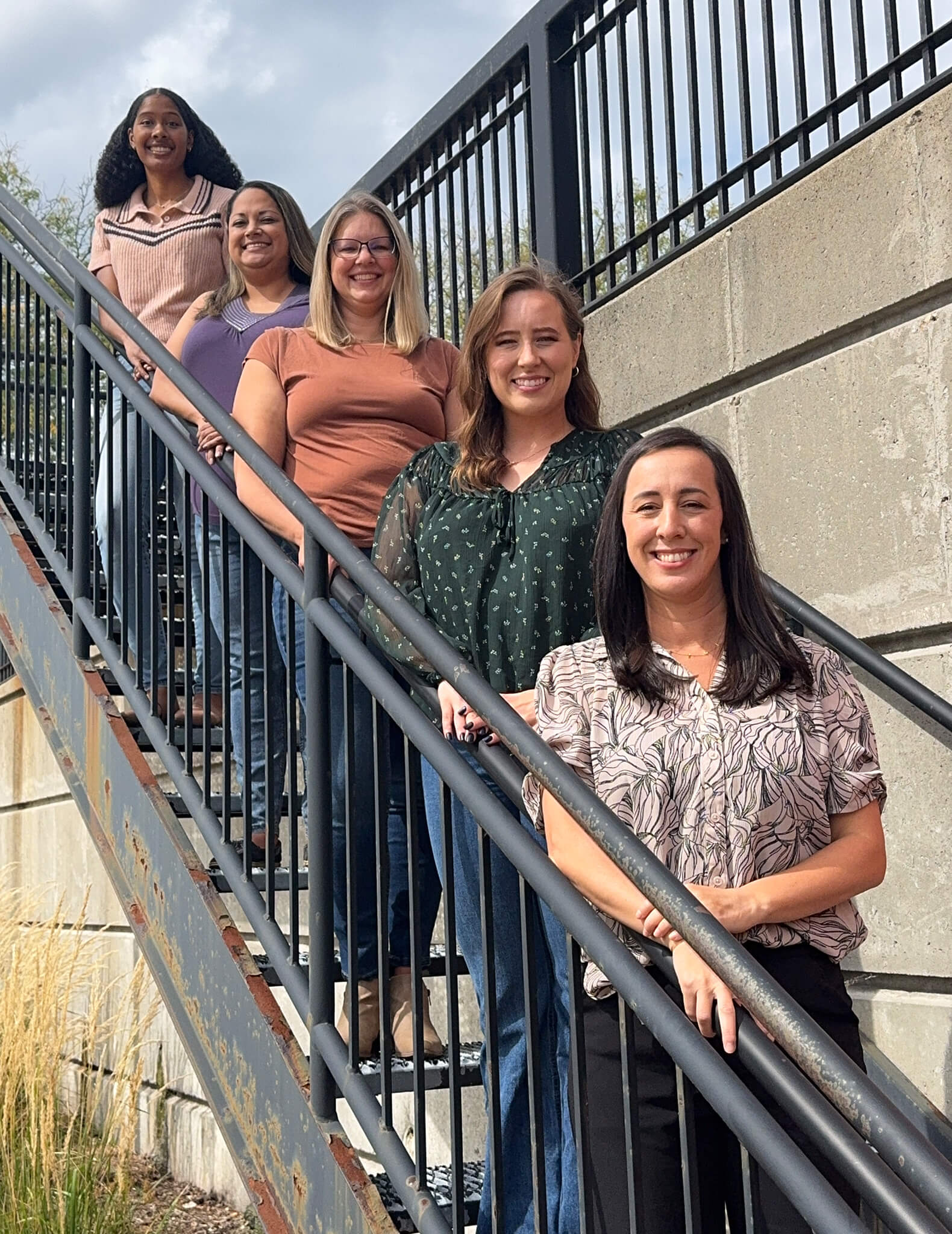 our team smiling outdoors