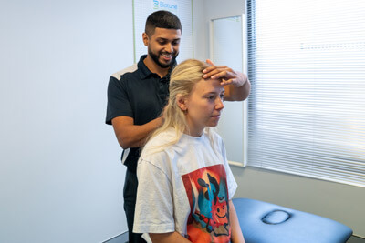 Dr Aneesh adjusting patients neck