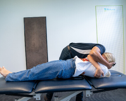 Dr. Aneesh adjusting patient on table