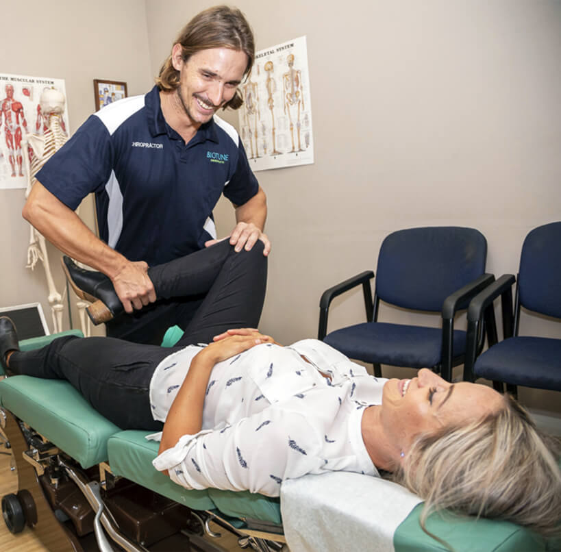 Chiropractor adjusting patient's knee