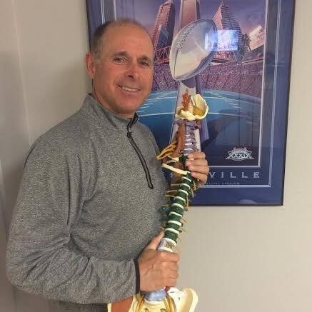 Philadelphia chiropractor posing with a model of a human spine