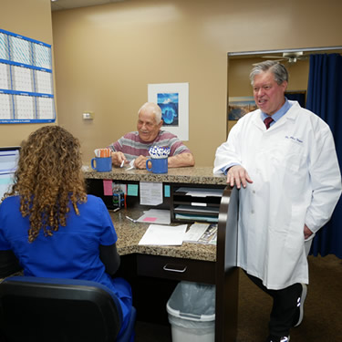 Doctor and patient standing at front desk