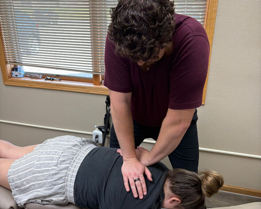 adjusting woman's back