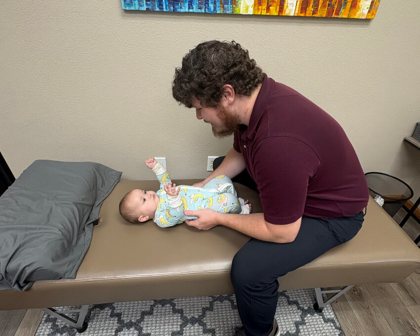 Brainerd Chiropractor Dr. Brenden Stay adjusting baby