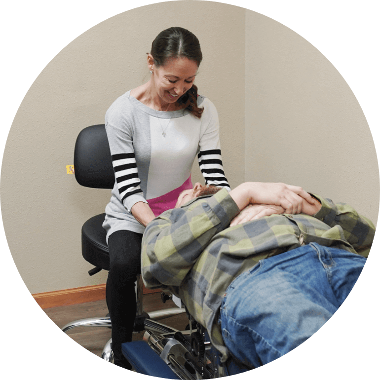 chiropractor adjusting patient on table