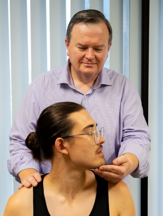 Dr. Adrian Sheridan adjusting patient