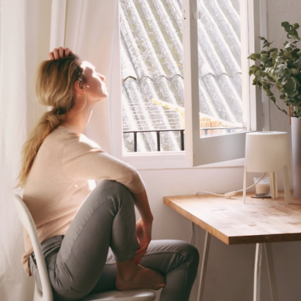 woman sitting near window