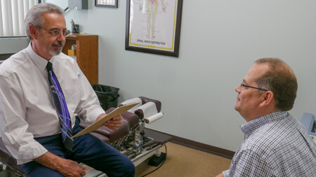 Dr Cutsinger talking to a patient