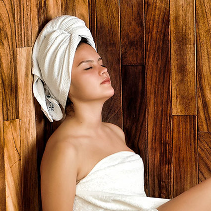 person relaxing in sauna