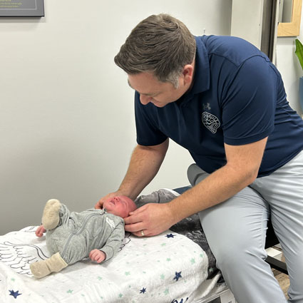 Doctor adjusting infant