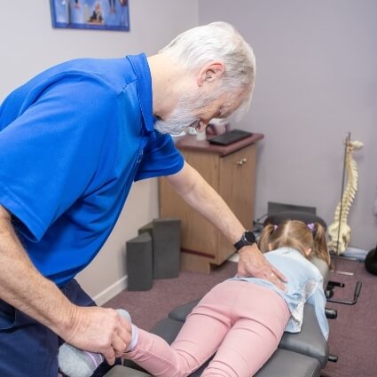 child patient having leg adjusted