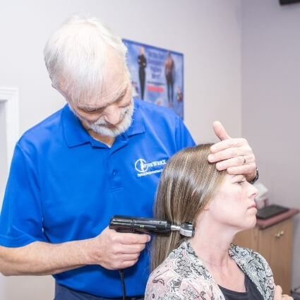 patient having neck adjusted with tool