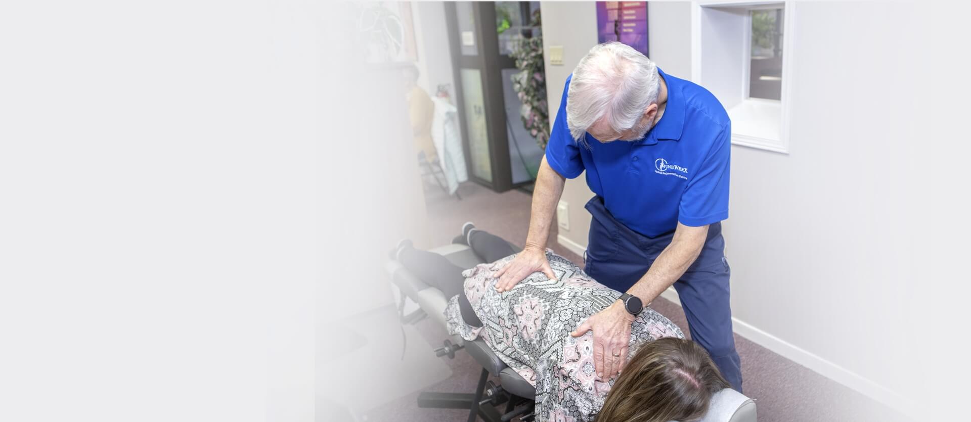 Lindsay chiropractor Dr Croutch adjusting patient laying on table