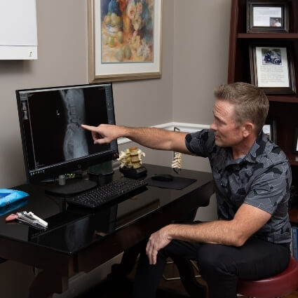 Dr Wright pointing at computer screen