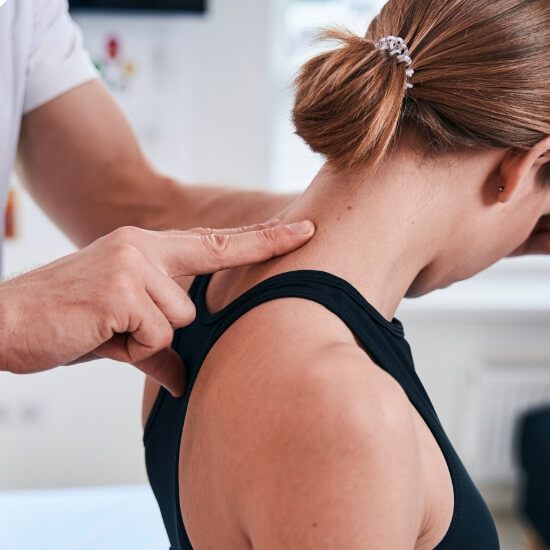 woman having neck examined