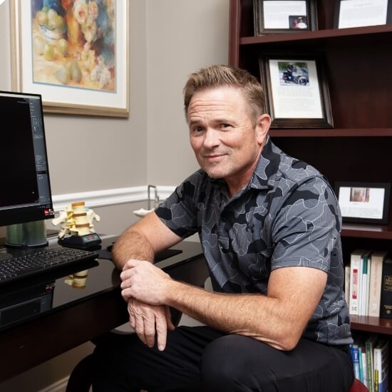 Belmont chiropractor Dr. David at his desk