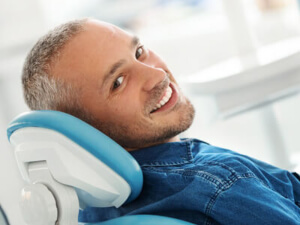 smiling man in dental chair