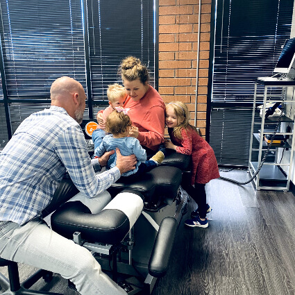 North Scottsdale Chiropractor Dr. Thomas Tuzzolino adjusting family