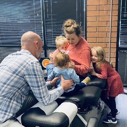 Dr Thomas adjusting mom with kids