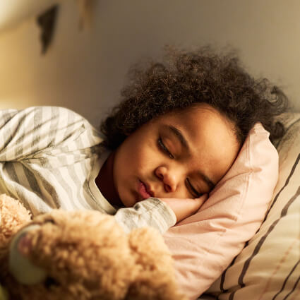 girl laying peacefully in bed