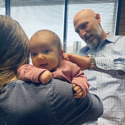 Dr Thomas adjusting baby in moms arms
