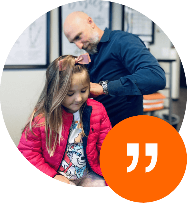 Elevate Chiropractic Chiropractor adjusting little girl