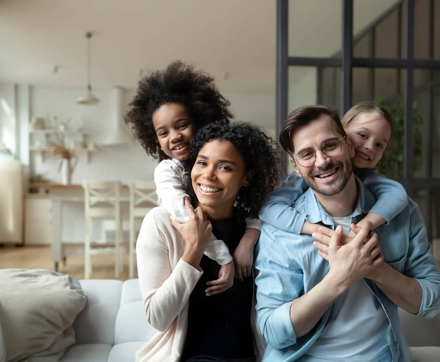 Happy mom, dad, and two young children