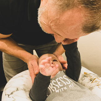Dr. Wilson adjusting a baby