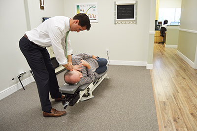 Dr. Jason Granger administering a NUCCA chiropractic adjustment. 