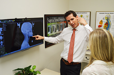 Dr. Jason Granger explaining xray results to a chiropractic patient. 