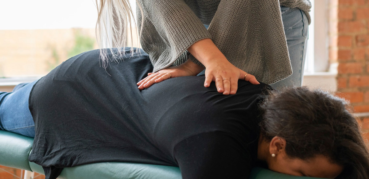 Dr Lutz adjusting patient on table