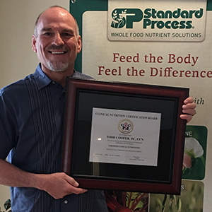 Dr. Cooper holding a certification