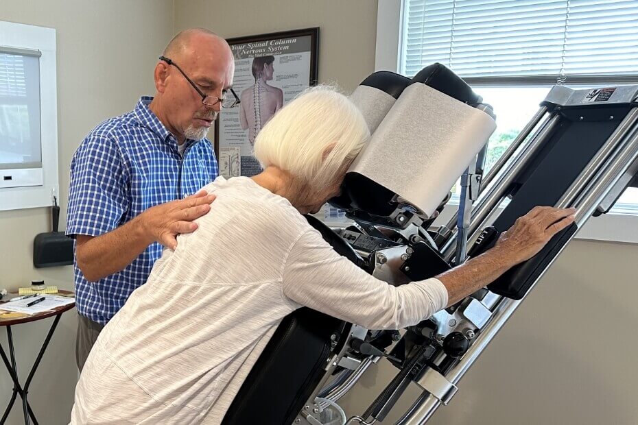 Chiropractor checking female patient