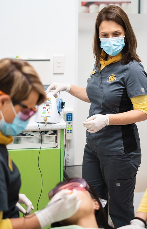 Dentist and staff working with patient