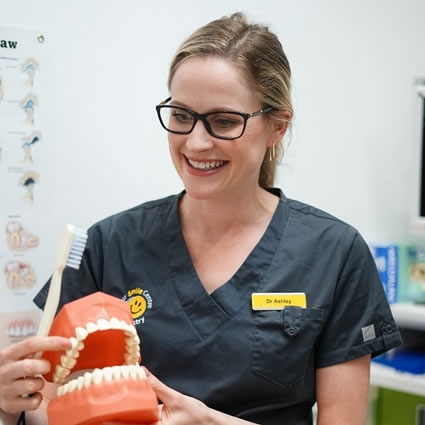 Dentist with model of teeth