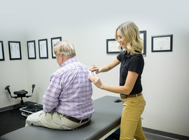 {PJ} chiropractor, Dr. Mark Johnson, adjusting a patient 