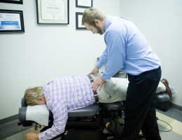 {PJ} chiropractor, Dr. Mark Johnson adjusting a patient