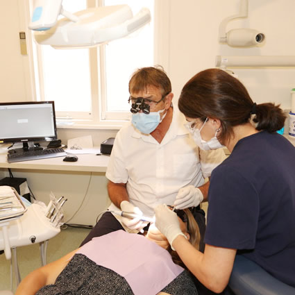 dentist with female patient and assistant