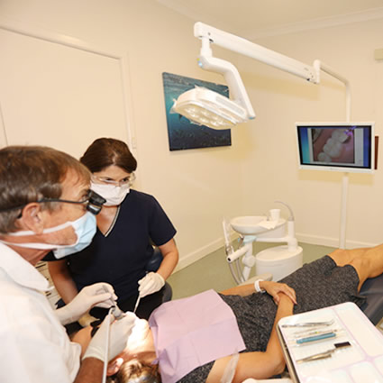 dentist with female patient in chair