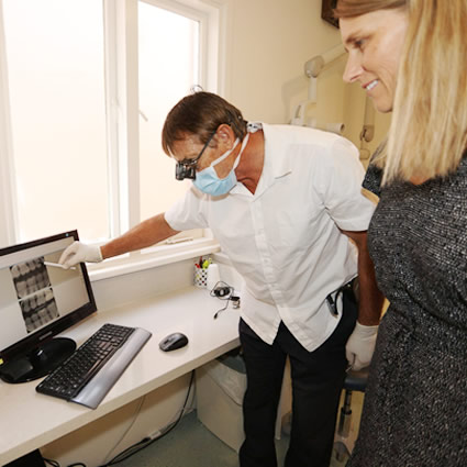 dentist and patient looking at xrays