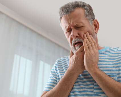 Man in pain from teeth grinding